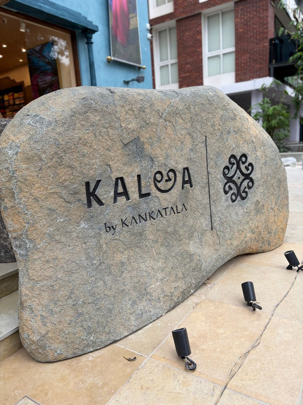 The KALఅA by Kankatala name carved into a granite boulder at the store entrance